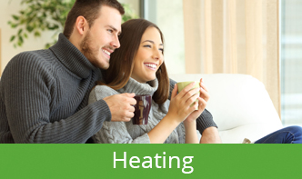 Heating Button Couple drinking coffee inside their warm home